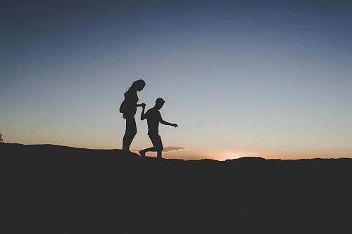 grand canyon national park silhouette of man and woman walking on mountain united states